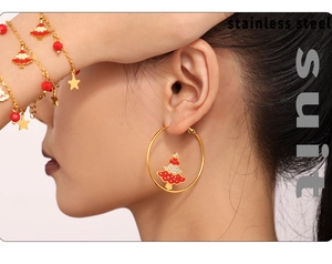 Close-up of stainless steel Christmas tree earrings and star bracelet on a model