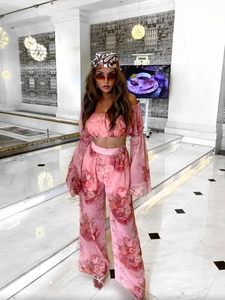 Detailed view of pink floral chiffon off-shoulder crop top and high-waist wide-leg pants