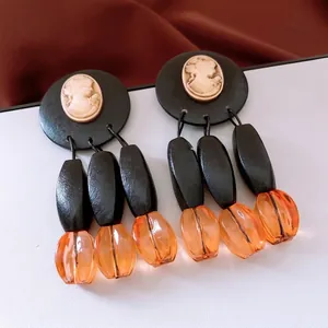 Vintage oval wood bead earrings with elegant cameo portrait and resin pendant