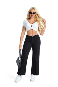 Detail of high waist wide leg denim trousers with patchwork and white crop top