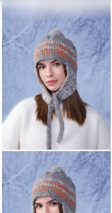 Detailed knit texture of grey earflap beanie with orange jacquard and pom-pom topper