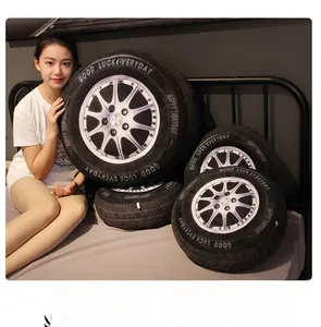 Detailed comparison of 3D tire plush pillows in various sizes on a minimalist bed