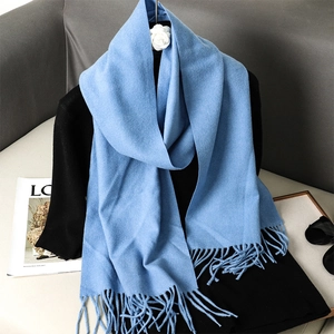 Sky blue cashmere feel scarf with fringes over black top, minimalist winter style