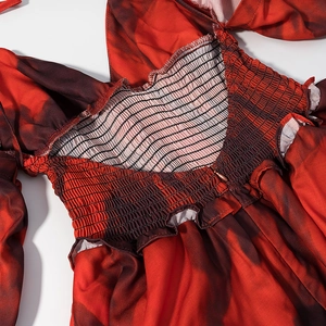 Close-up of smocked waist with red marble print and invisible zipper detail