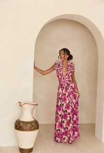 Detail of pink floral maxi dress with waist cut-out and deep V-neck for summer vacation