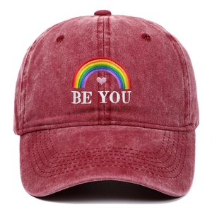 Detailed embroidery of rainbow, pink heart, and BE YOU text on washed cotton cap