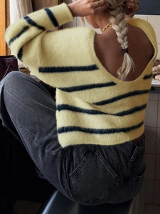 Detailed back view of a soft striped knit sweater featuring a deep V-neck design