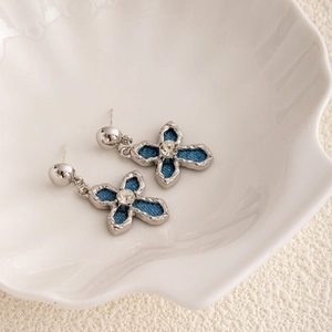 Elegant silver four-leaf flower earrings with blue denim inlays and crystal centers