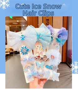 Detail of Frozen themed hair clips featuring blue tulle bows and snowflake accessories