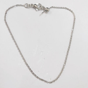 Close-up of minimalist silver paperclip chain with lobster clasp and adjustable bead detail