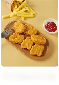 Close-up of realistic chicken nuggets and fries model on a wooden tray with a fork