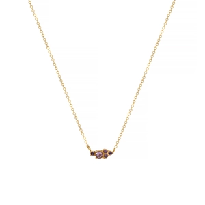 Detail of round purple gemstones on an 18k gold plated stainless steel necklace chain