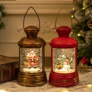 Christmas lantern snow globe with Santa and Snowman in bronze and red finish
