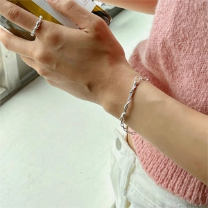 Detailed view of handmade S925 sterling silver twisted chain bracelet on a female wrist
