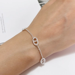 Minimalist S925 sterling silver chain bracelet with oval beads on a woman's wrist