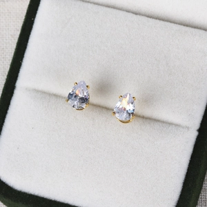 Macro detail of teardrop cubic zirconia earrings in a premium green jewelry box