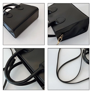 Detail view of black PU leather handbag with golden hardware and adjustable strap