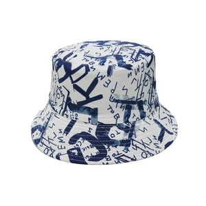 Dettaglio di un cappello da pescatore bianco con stampa graffiti blu e trama del tessuto