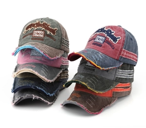 Macro detail of distressed washed cotton baseball caps with 1969 embroidery in multi-colors