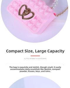 Pink silicone heart pop bag detail with pearl handle and golden heart lock