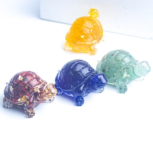 Detailed view of four colorful turtle figurines made of natural crystal and resin