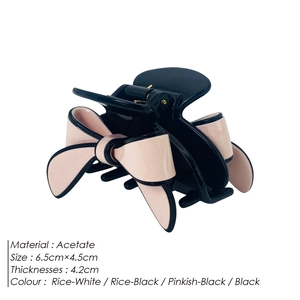 Elegant black and pink acetate bow hair claw clip measuring 6.5cm x 4.5cm on white background