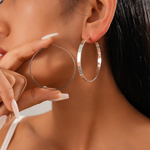 Polished silver geometric hoop earrings in a minimalist metallic round design for women