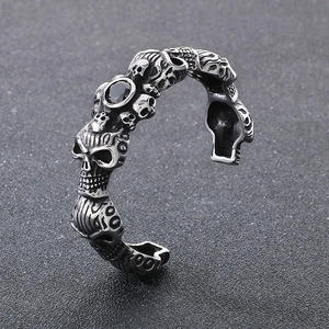 Macro detail of gothic skull bracelet with black zircon inlay and aged steel finish