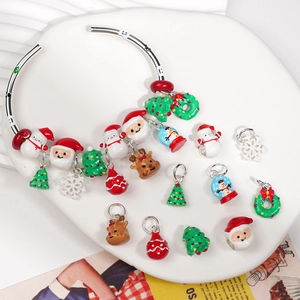 Christmas enamel charms set with Santa, snowmen and reindeer on a silver bangle bracelet