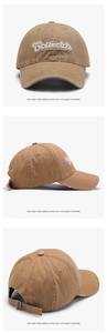 Detail of 3D embroidery and distressed brim on a dark khaki cotton baseball cap