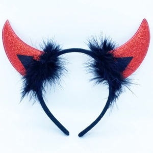 Detailed view of red glitter devil horns with black feather trim on a sleek headband