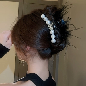 Elegant hair claw with black feathers, white pearls and crystals for women's updos