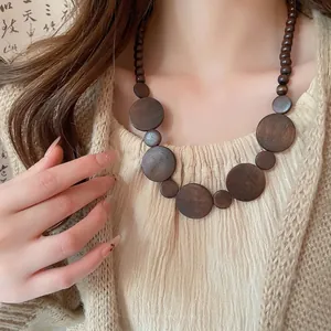 Vintage wooden beaded necklace with geometric round pendants in bohemian ethnic style