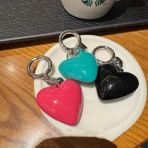 Three glossy resin heart keychains in pink, turquoise and black with silver metal rings