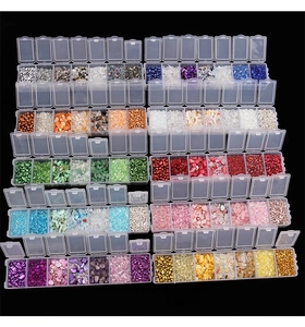 Detailed view of 7-grid boxes filled with colorful iridescent crushed glass for DIY crafts