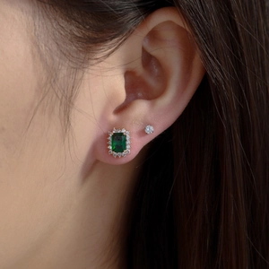 Emerald cut green stone earrings with diamond halo and minimalist stud in gold finish