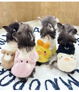 Detail of plush fleece pet vests with cute animal embroidery and metal D-rings for leashes