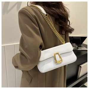 Detailed side view of white flap crossbody bag with gold chain and unique buckle