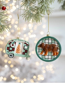 Detailed view of resin Christmas ornaments featuring a camper van and brown bear on a tree