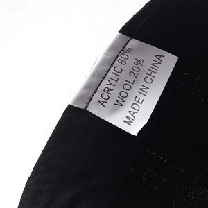 Detail of hip hop baseball cap label showing 80% acrylic and 20% wool composition