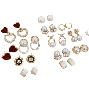 French vintage pearl earring set with crystal fishtail and heart studs on white background