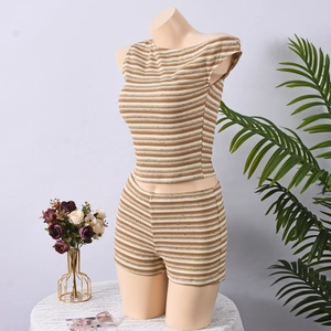 Detailed close-up of striped knit two-piece set featuring ribbed fabric and cropped fit