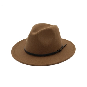 Detail of brown wool fedora hat featuring a black leather band and gold metal buckle