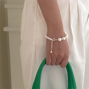 Minimalist 925 sterling silver bracelet featuring varied white pearls and adjustable clasp