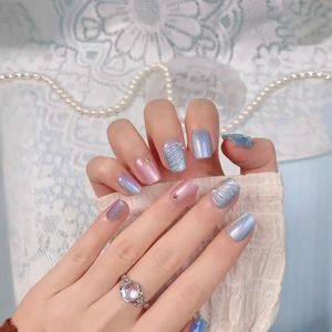 Handmade gradient pink and blue press-on nails with shell textures and gold star accents