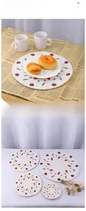 Detail of round woven cotton placemats featuring vintage strawberry print and varied sizes