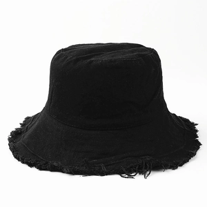 Detail shot of black canvas bucket hat showing the frayed edge and vintage distressed texture