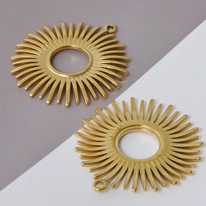 Detailed view of two golden sunburst charms made of 304 stainless steel for DIY jewelry
