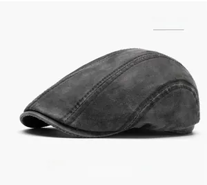 Detailed close-up of dark grey newsboy hat with reinforced stitching and matte texture