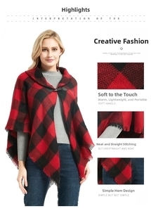 Close-up of the red buffalo plaid poncho fabric, horn buckle detail and fringe hemline
